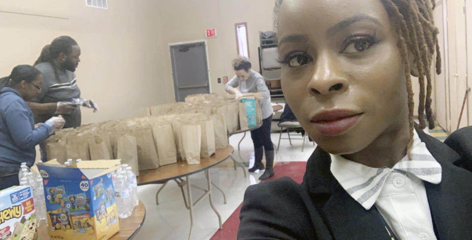 This undated photo provided by Hattie Norwood in July 2020 shows her during efforts by the group Proactive Community Involvement to deliver free meals daily to hungry children in Saginaw, Mich. At just 31, she's already witnessing the second major recession of her adult life. Norwood sees Saginaw's problems -- crime, poverty, struggling schools, food deserts -- as entrenched. "Deja vu," she says. (Hattie Norwood via AP)