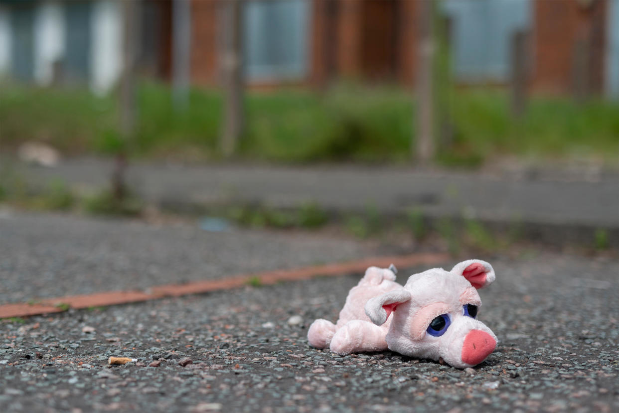 A child's toy lies on the ground outside some boarded up abandoned houses on the High Street estate in Pendleton, Salford, Greater Manchester, UK