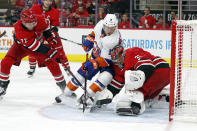 New York Islanders' Anthony Beauvillier (18) is challenged by Carolina Hurricanes goaltender Frederik Andersen (31) with Hurricanes' Brett Pesce (22) nearby during the third period of an NHL hockey game in Raleigh, N.C., Thursday, Oct. 14, 2021. (AP Photo/Karl B DeBlaker)
