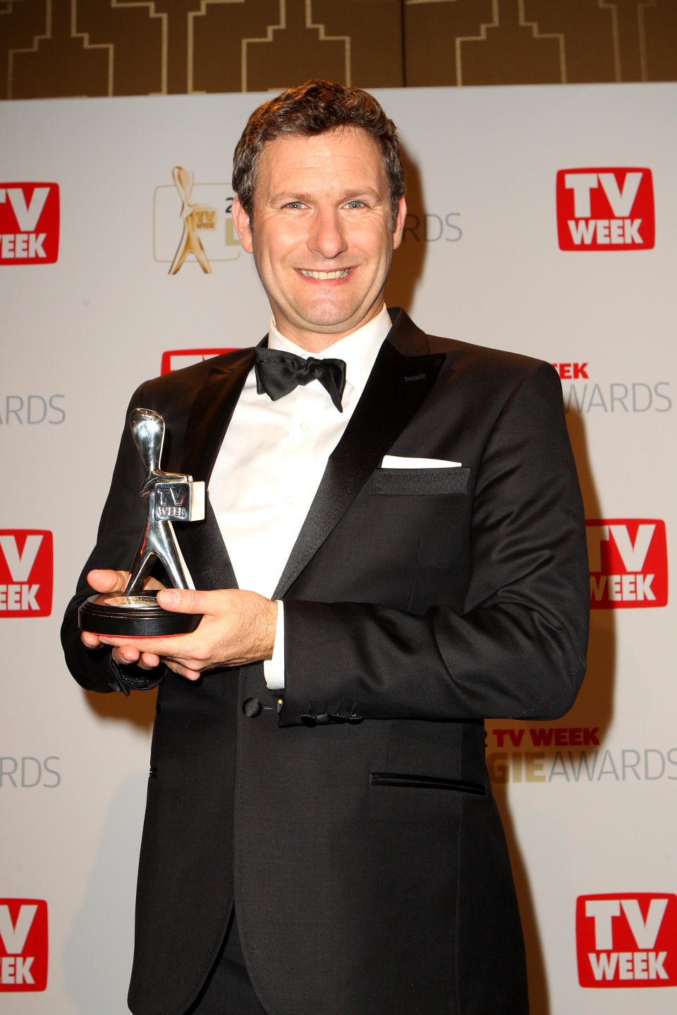  Adam Hills poses after winning the Silver Logie for Most Popular Presenter at the 2012 Logie Awards