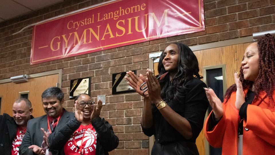 Crystal Langhorne, 2nd from right, a Willingboro High School graduate and former WNBA player, takes part in a ceremony held to celebrate the Willingboro High School gym being renamed after Langhorne on Wednesday, December 13, 2023.