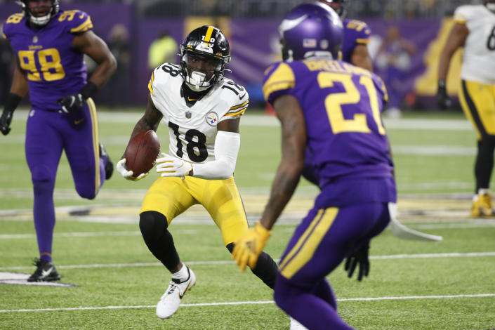 Pittsburgh Steelers wide receiver Diontae Johnson (18) runs from Minnesota Vikings cornerback Bashaud Breeland (21) after catching a pass during the first half of an NFL football game, Thursday, Dec. 9, 2021, in Minneapolis. (AP Photo/Bruce Kluckhohn)