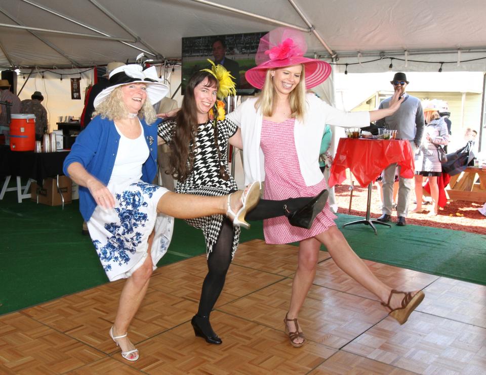 In this file photo, Jenny Nelson, Nancy Shue and Ann Wallace kick up their heels to the Beer Barrel Polka at a previous Maxie's Derby Day party.