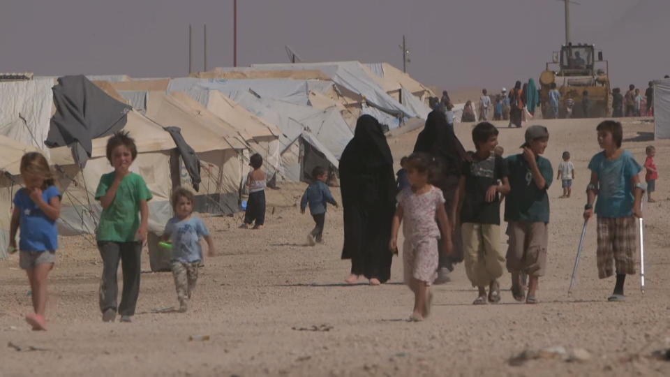 Refugees walk inside the Al-Hol refugee camp in Syria. / Credit: CBS News