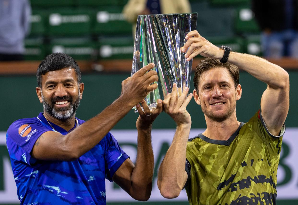 Rohan Bopanna of India (left) and Matthew Ebden of Australia hold up their trophy after winning the men's doubles final over Wesley Koolhof of the Netherlands and Neal Skupski of Great Britain at the BNP Paribas Open at the Indian Wells Tennis Garden in Indian Wells, Calif., Saturday, March 18, 2023.