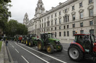 Farmers from the group Save British Farming drive tractors around Parliament Square, in London, in a protest against cheaply produced lower standard food being imported from the U.S. after Brexit that will undercut them, Wednesday, July 8, 2020. (AP Photo/Matt Dunham)