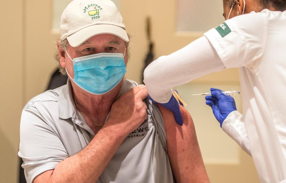 Kirk Harrington gets a COVID-19 vaccine from Augusta Tech nursing student Alexis Tyler during University Hospital's first public vaccination clinic at First Baptist Church of Augusta on Jan. 22, 2021.