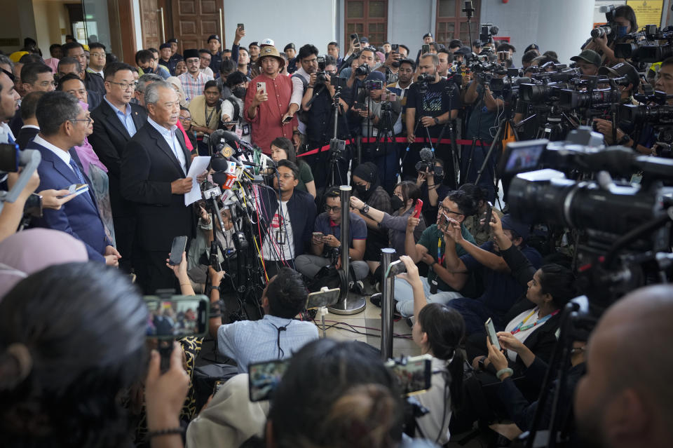 Malaysia's former Prime Minister Muhyiddin Yassin, left, speaks to media outside courthouse, after charged with corruption and money laundering, in Kuala Lumpur, Malaysia, Friday, March 10, 2023. Muhyiddin has has been charged with corruption and money laundering, making him Malaysia's second ex-leader to be indicted after leaving office. Muhyiddin pleaded innocent Friday to four charges of corruption and two charges of money laundering. (AP Photo/Vincent Thian)