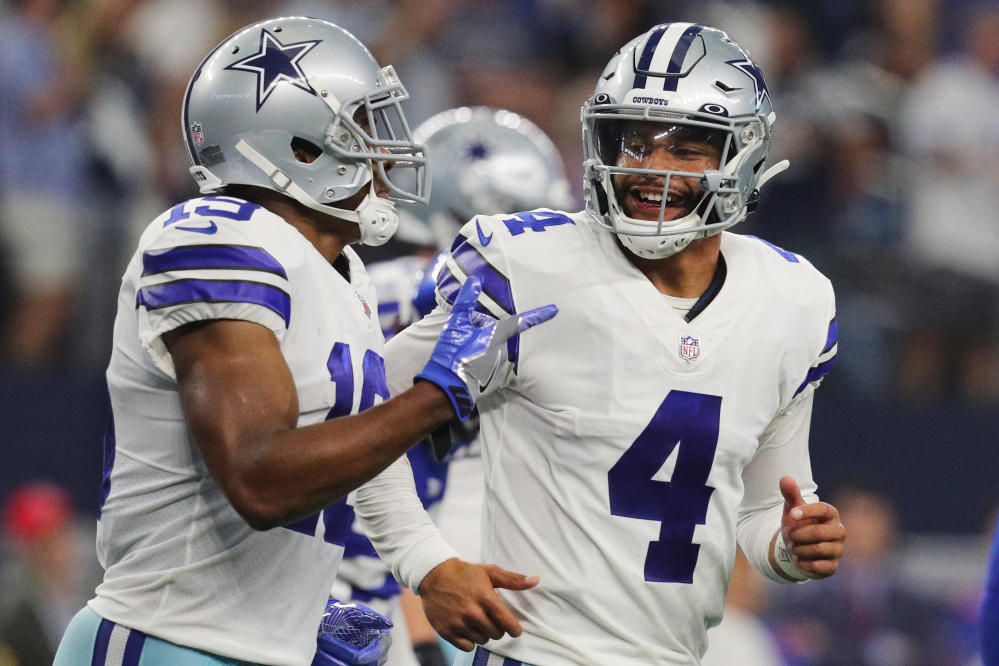 Dallas Cowboys' Osa Odighizuwa (97) and Damontae Kazee (18) celebrate with  Trevon Diggs (7) after Diggs intercepted a pass in the second half of an  NFL football game against the Carolina Panthers