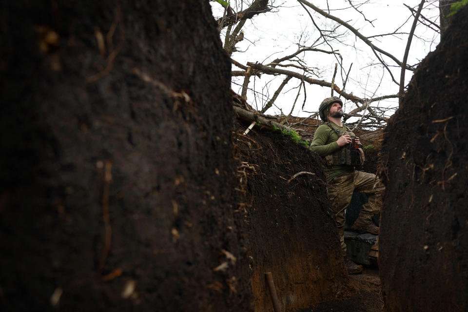 A Ukrainian serviceman reacts to incoming artillery shelling in a trench on the frontline on Saturday, April 8. 