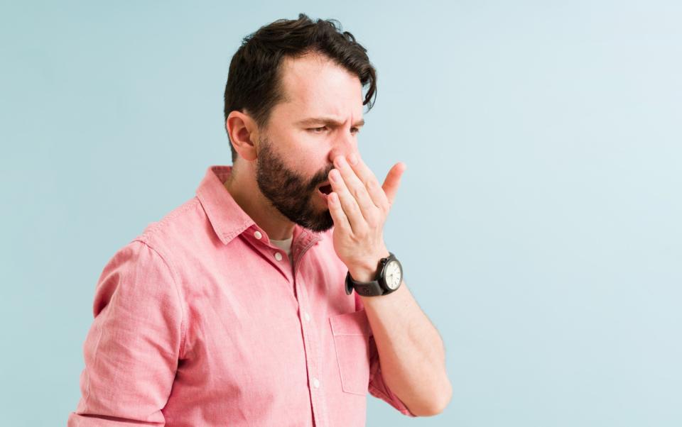 Man checking and smelling his bad breath