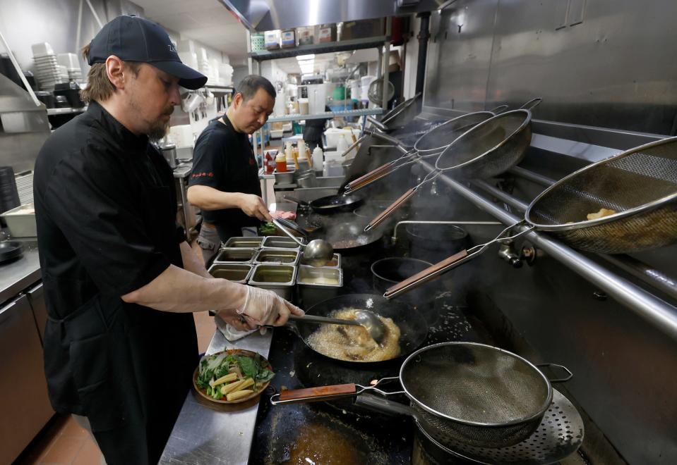 Chef Ron Donegan prepares another order in the kitchen at Zao Jun New Asian restaurant in Bloomfield Township on Tuesday, Jan. 24, 2023.