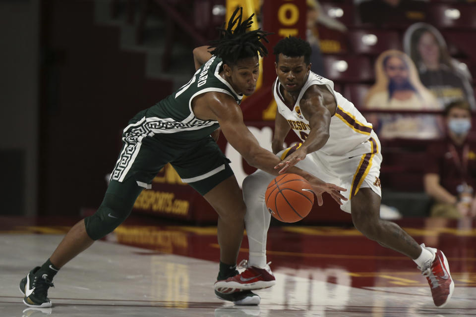 Michigan State's A.J. Hoggard (11) and Minnesota's Jamal Mashburn Jr. (4) go after the ball during the second half of an NCAA college basketball game, Monday, Dec. 28, 2020, in Minneapolis. Minnesota won 81-56. (AP Photo/Stacy Bengs)