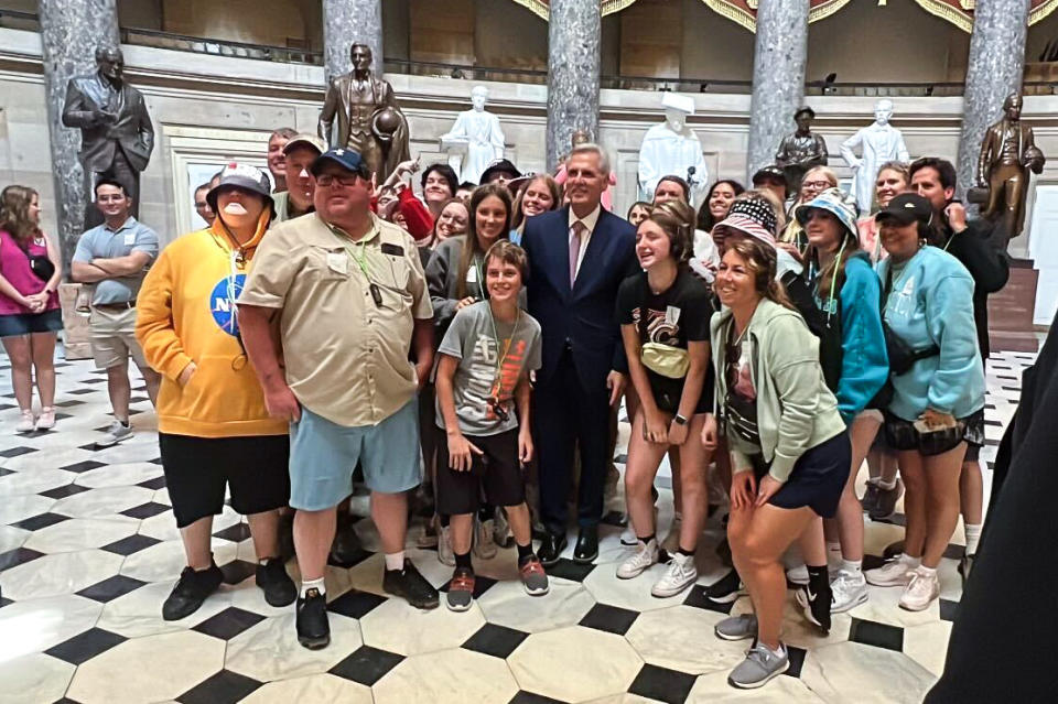 House Speaker Kevin McCarthy poses with the tourists in the U.S. Capitol on June 8, 2023. (Frank Thorp V / NBC News)