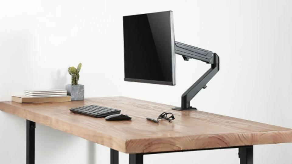 Make room for everything else on your desk by putting your monitor on this desk mount stand from Staples Canada.(Image via Staples Canada)