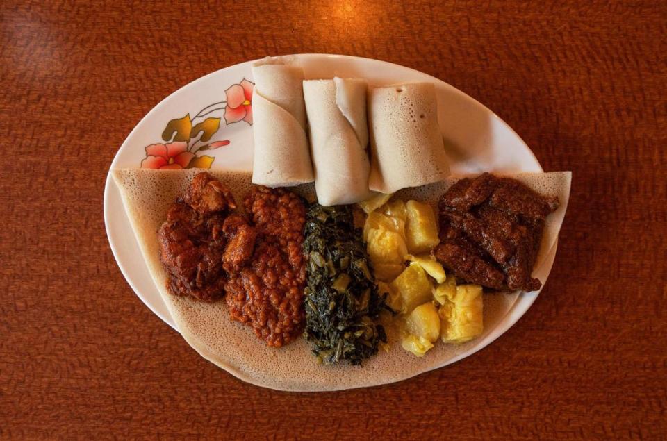 .The sampler platter featuring chicken, lentils, greens, cabbage and lamb, served atop injera bread, is one of the most popular at Blue Nile Cafe.