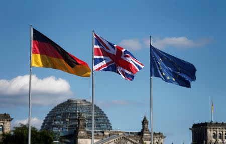 German, British and European Union flags fly in front of the Reichstag building in Berlin, Germany July 20, 2016. REUTERS/Hannibal Hanschke/File Photo