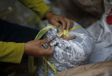 North Korean defector Lee Min-bok sets up a timer to release leaflets from a balloon after they cross into North Korea condemning its dictatorship, as he prepares balloons at his home in Pocheon, about 15 km south of the demilitarized zone separating the two Koreas, October 15, 2014. REUTERS/Kim Hong-Ji