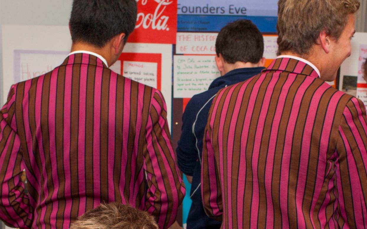 Pupils at Fettes College, a private school in Edinburgh, wearing their distinctive school blazer - Getty Images