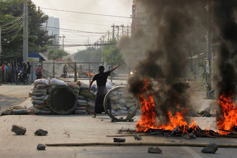 Demonstrators gather behind barricades during a protest against the military coup in Mandalay