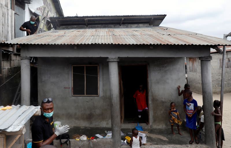 An employee of Salpha Energy installs a solar panel on the roof of one of the homes in Sagbo-Kodji community in Lagos