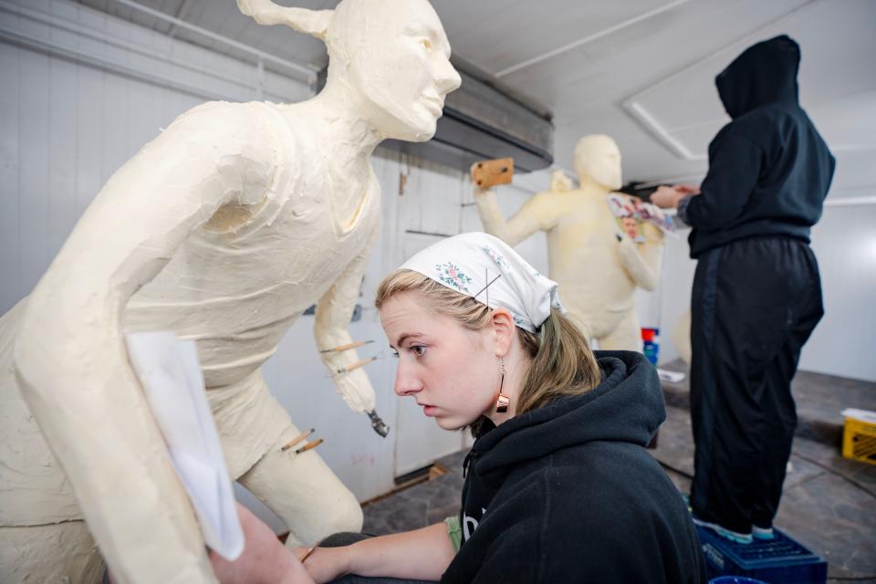 Hannah Pratt, left, works on a butter sculpture of Caitlin Clark while her sister Grace Pratt works on one of quarterback Kurt Warner in the Agriculture building at the Iowa State Fairgrounds, Tuesday, Aug. 8, 2023.