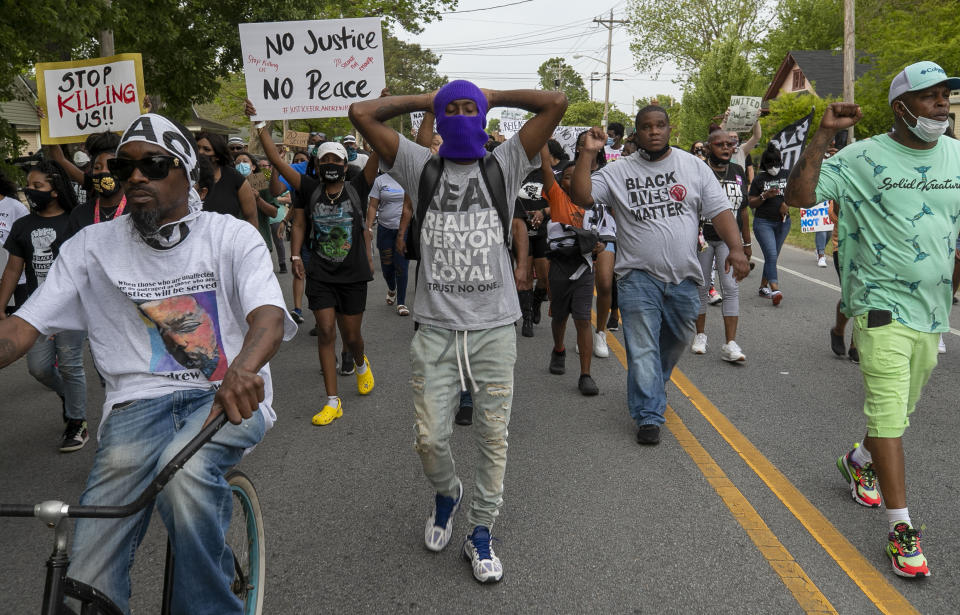 Elizabeth City Councilman Gabriel Adkins, second from right wearing a Black Lives Matter shirt, helps lead demonstrators on a march through Andrew Brown Jr.'s neighborhood, Thursday, April 29, 2021, in Elizabeth City, N.C., Thursday, April 29, 2021. This is the ninth day of demonstrations in the wake of Andrew Brown Jr.'s death at the hands of Pasquotank County deputies. (Robert Willett/The News & Observer via AP)