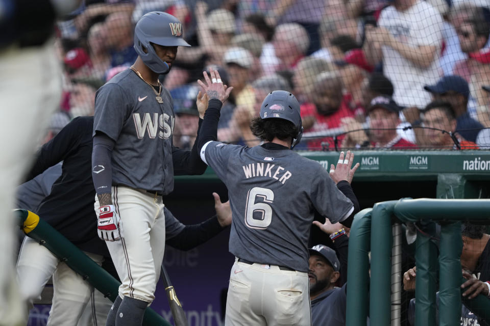 Washington Nationals outfielder Jesse Winker (6) is congratulated by teammate Joey Meneses, left, after scoring during the second inning of a baseball game against the Baltimore Orioles at Nationals Park in Washington, Tuesday, May 7, 2024. (AP Photo/Susan Walsh)