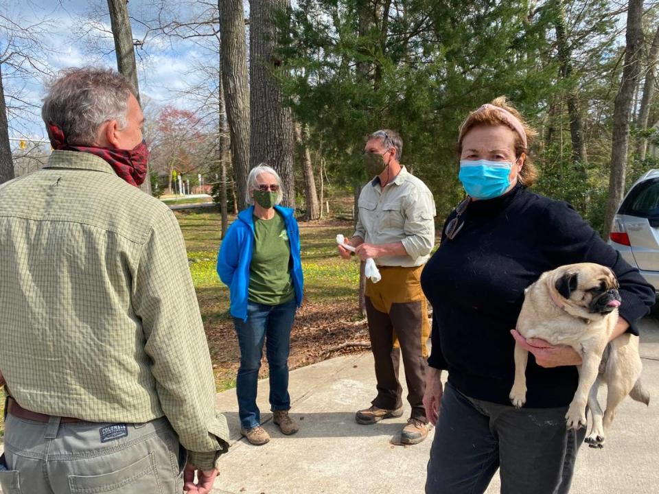 Botanical experts met with the Hammers to discuss their fig buttercup invasion. From left to right, Johnny Randall, Ann Prince, Pete Schubert and Valerie Hammer, holding her pug Bonnie.