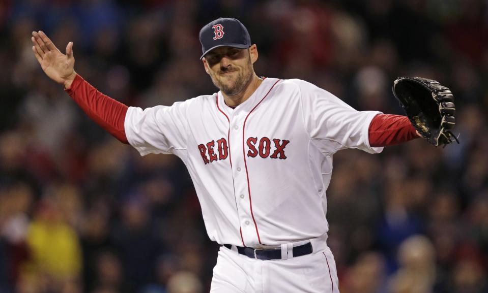 Boston Red Sox starting pitcher John Lackey reacts after getting Texas Ranger J.P. Arencibia to ground out to end the top of the seventh inning of a MLB American League baseball game at Fenway Park, Monday, April 7, 2014, in Boston.(AP Photo/Charles Krupa)