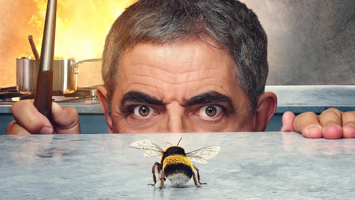  Rowan Atkinson as Trevor Bingley in a Man vs. Bee promotional image for Netflix, staring at a bee 