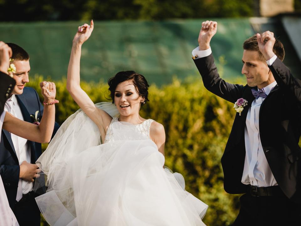 bride and groom dancing into wedding reception