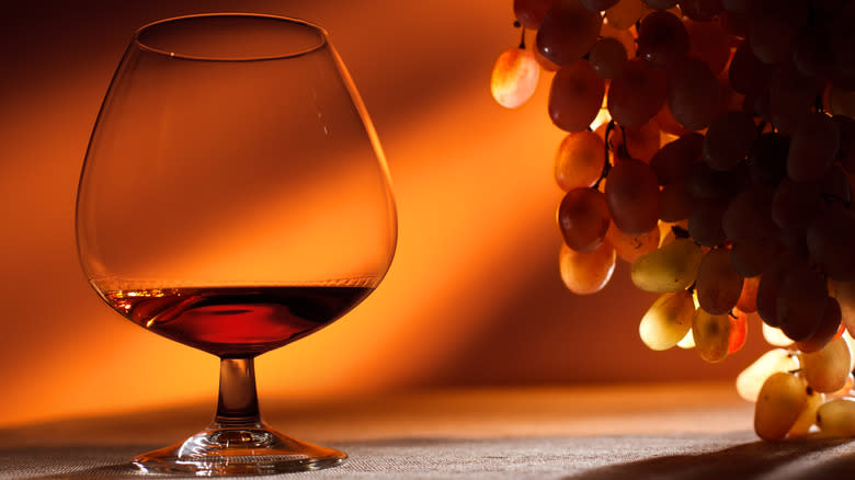 glass of brandy with grapes