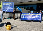 Activists protest before the annual general Volkswagen meeting in Berlin