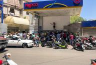 People queue for fuel at a gas station in Beirut