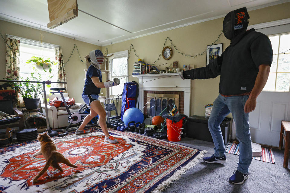 PRINCETON, NEW JERSEY - MAY 28: U.S. Olympic fencer Katharine Holmes (L) trains with her boyfriend Tyler Christensen during a training session at her home on May 28, 2020 in Princeton, New Jersey. An Olympian, World Championship gold medalist and Pan American gold medalist - Holmes continues to focus on winning gold at the Tokyo 2020 Olympics - which have been postponed to 2021 due the coronavirus. The epee fencer was training anywhere from 6-8 hours a day at Princeton University before the Covid-19 pandemic, but now continues that intense regime at home. That includes using her boyfriend, who is a rock climber and ecologist, to stand in for her lessons. Athletes across the globe are now training in isolation under strict policies in place due to the Covid-19 pandemic. (Photo by Patrick Smith/Getty Images)