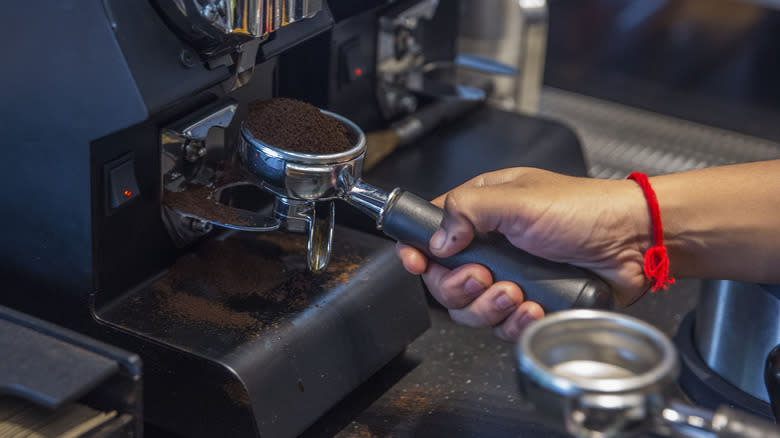 Person using espresso machine