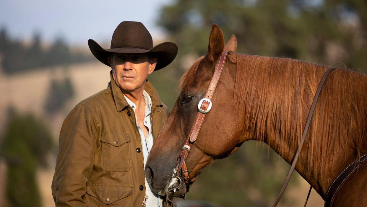  Kevin Costner as John Dutton, next to a horse, in "Yellowstone". 