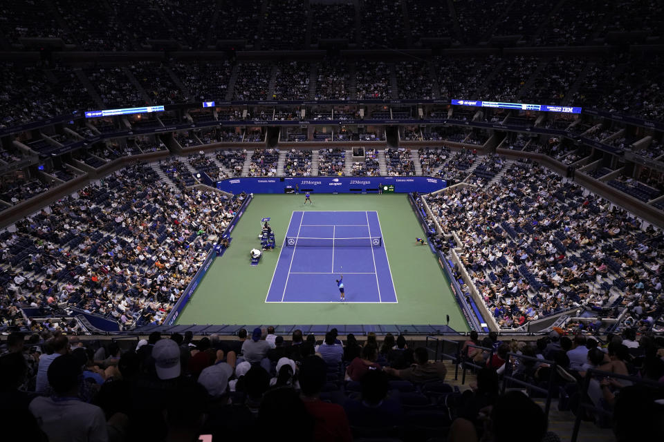 Novak Djokovic, foreground, of Serbia, serves to Matteo Berrettini, of Italy, during the quarterfinals of the U.S. Open tennis tournament at Arthur Ashe Stadium, Wednesday, Sept. 8, 2021, in New York. (AP Photo/Frank Franklin II)