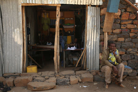 A man sits infront of a tailor house in Badme, territorial dispute town between Eritrea and Ethiopia currently occupied by Ethiopia, June 8, 2018. Picture taken June 8, 2018. REUTERS/Tiksa Negeri