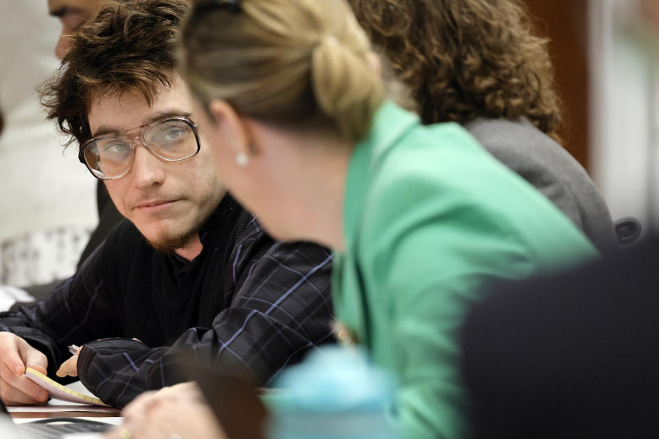 Marjory Stoneman Douglas High School shooter Nikolas Cruz listens to Assistant Public Defender Melisa McNeill during jury selection in the penalty phase of his trial at the Broward County Courthouse in Fort Lauderdale on Monday, June 6, 2022. Cruz previously plead guilty to all 17 counts of premeditated murder and 17 counts of attempted murder in the 2018 shootings. (Amy Beth Bennett/South Florida Sun Sentinel via AP, Pool)