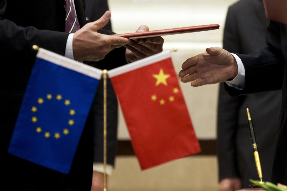 FILE - A member of European Commission, left, prepares to exchange documents with Chinese delegation at a signing ceremony after the 5th China-EU High Level Economic and Trade dialogue at Diaoyutai State Guest House in Beijing, on Sept. 28, 2015. China’s Commerce Ministry announced Wednesday, July 10, 2024 it will launch an investigation into whether unfair trade practices were adopted by the European Union in its probe of Chinese companies. (AP Photo/Andy Wong, File)