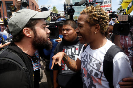 A Trump supporter (L) debates with a demonstrator opposed to Republican U.S. presidential candidate Donald Trump, before Trump's campaign event in San Diego, California, U.S. May 27, 2016. REUTERS/Jonathan Alcorn