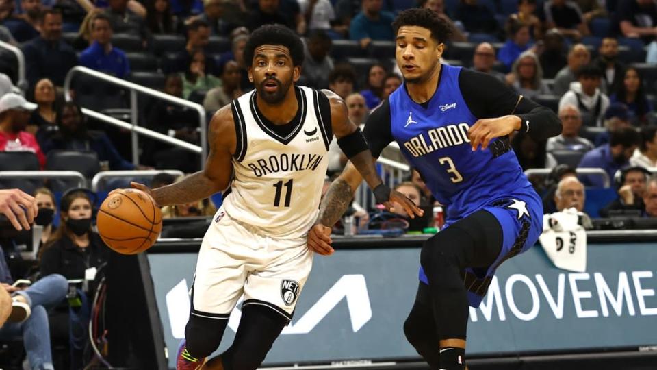 Mar 15, 2022; Orlando, Florida, USA; Brooklyn Nets guard Kyrie Irving (11) drives to the basket as Orlando Magic forward Chuma Okeke (3) defends during the second quarter at Amway Center.