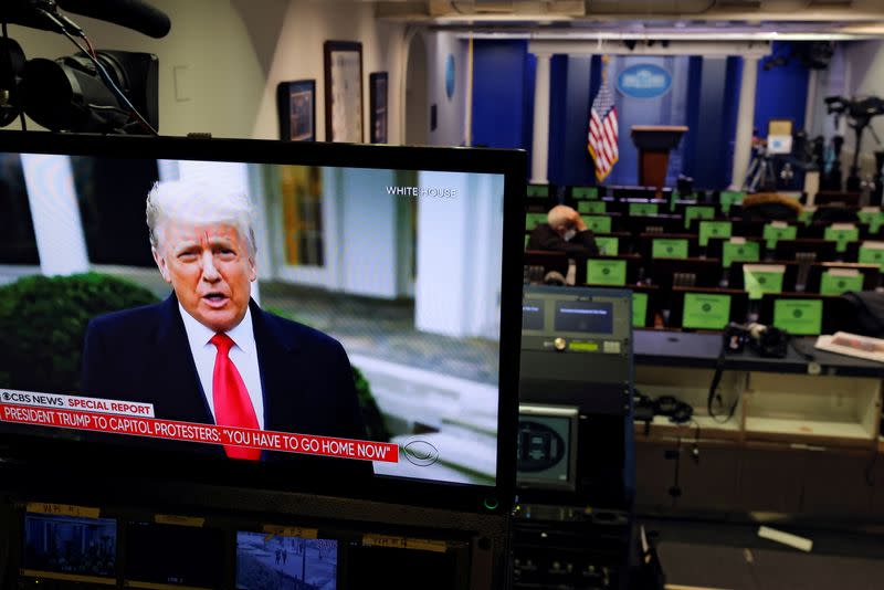 U.S. President Donald Trump is seen making remarks on a television monitor from the White House Briefing Room