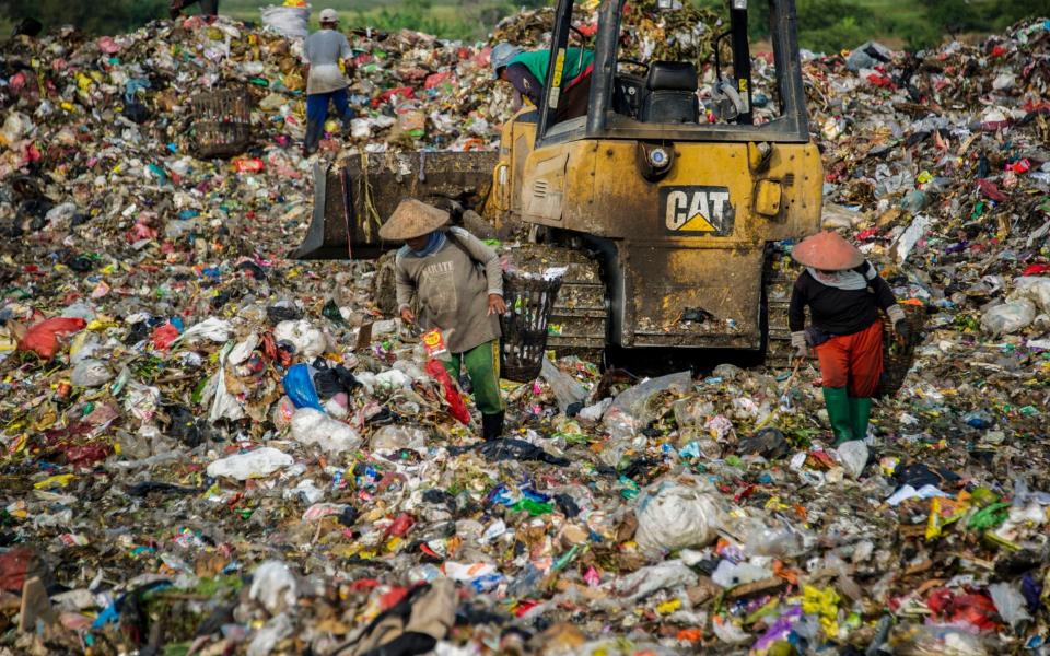 Scavengers collect valuable waste at Sidoarjo garbage dump in East Java. Over half of the plastic dumped in the world's oceans comes from five Asian countries: China, Indonesia, the Philippines, Thailand and Vietnam - AFP