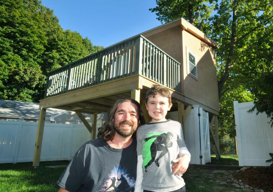 Evan Thomas, left, joins his son, Harrison Cummings-Thomas, 6, outside Harrison's treehouse at their North Weymouth home Thursday, Oct. 6, 2022.