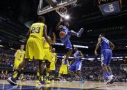Kentucky's Alex Poythress dunks during the first half of an NCAA Midwest Regional final college basketball tournament game against Michigan Sunday, March 30, 2014, in Indianapolis. (AP Photo/Michael Conroy)