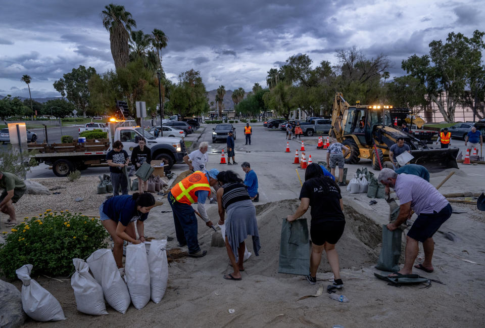 With storm clouds looming overhead from Hurricane Hilary, residents quickly fill sandbags outside City Hall  on Aug. 19, 2023 at City Hall in Palm Springs, California.  / Credit: Gina Ferazzi / Los Angeles Times via Getty Images