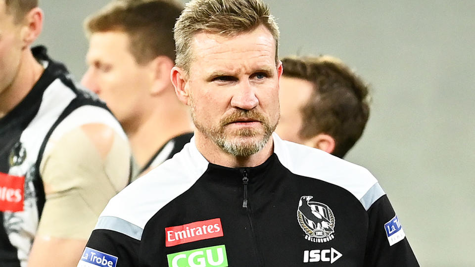 Collingwood coach Nathan Buckley is pictured walking off the field after addressing the players.